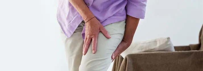 A person holding their leg in pain