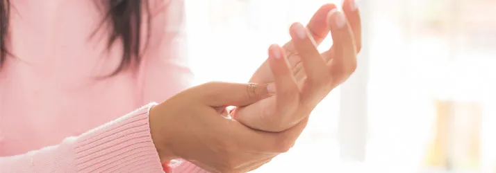 A woman holding her hand.